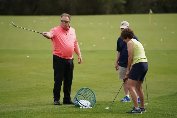 Instructor coaching a group clinic on the range
