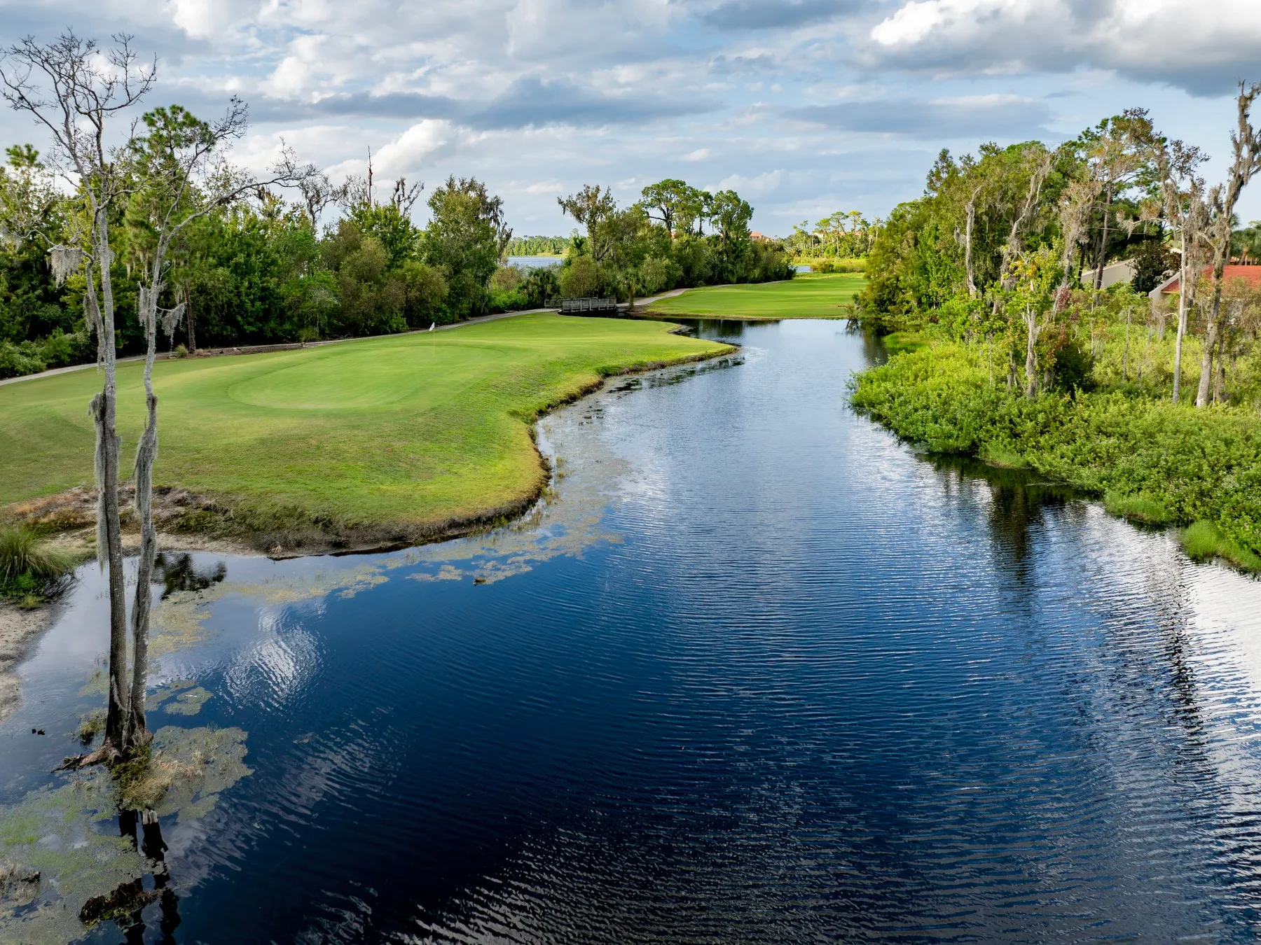 Creek winding toward the green on hole 4 at Crane’s Bend