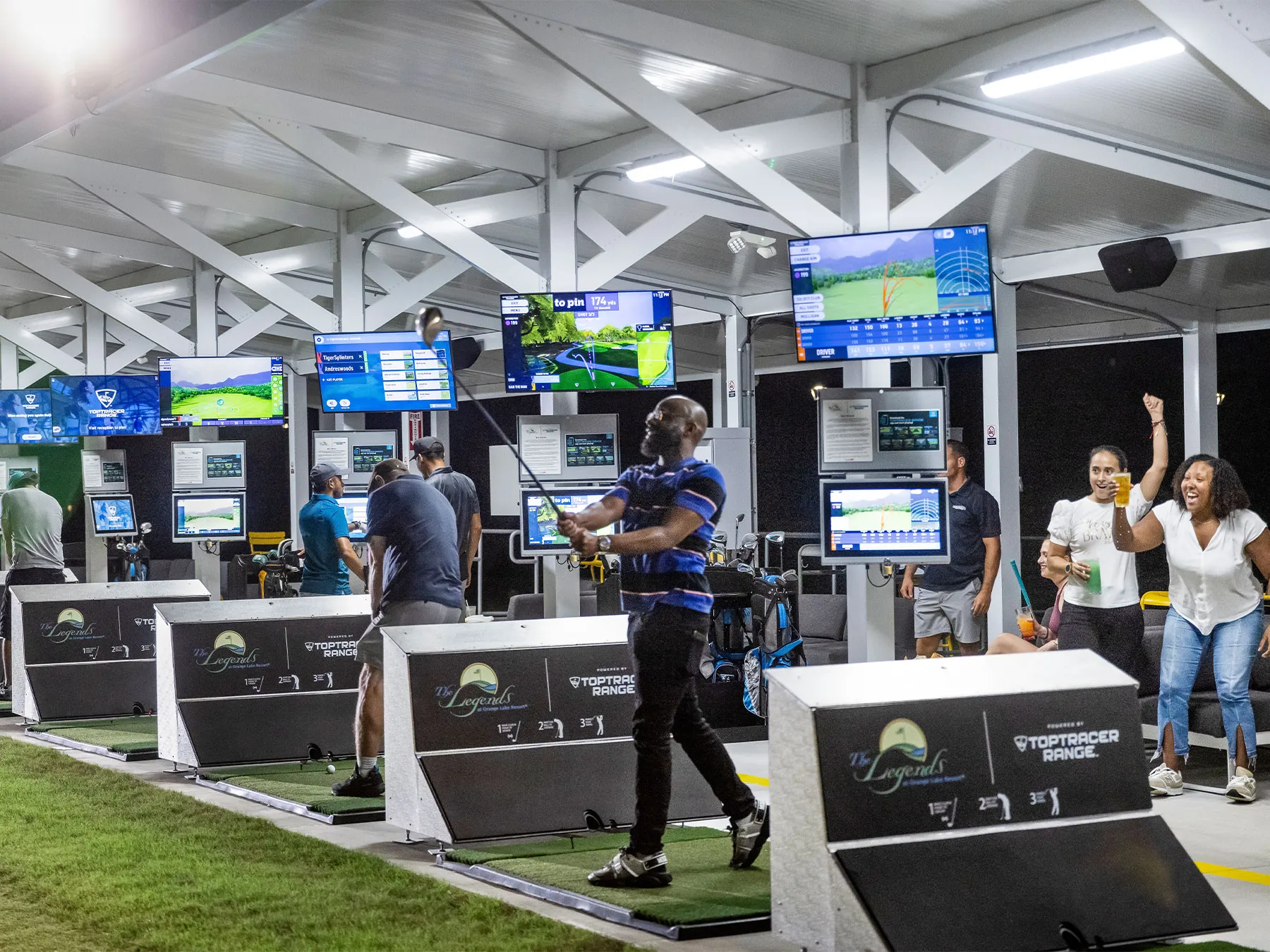 Friends playing in the Toptracer bays at night